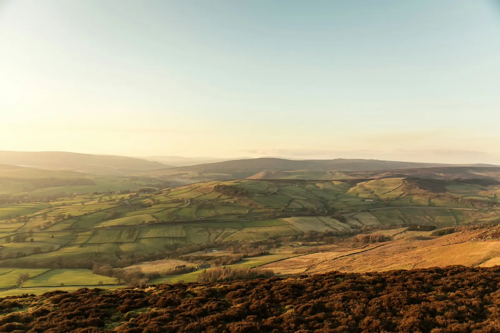 Brown and green Yorkshire fells under a white sky